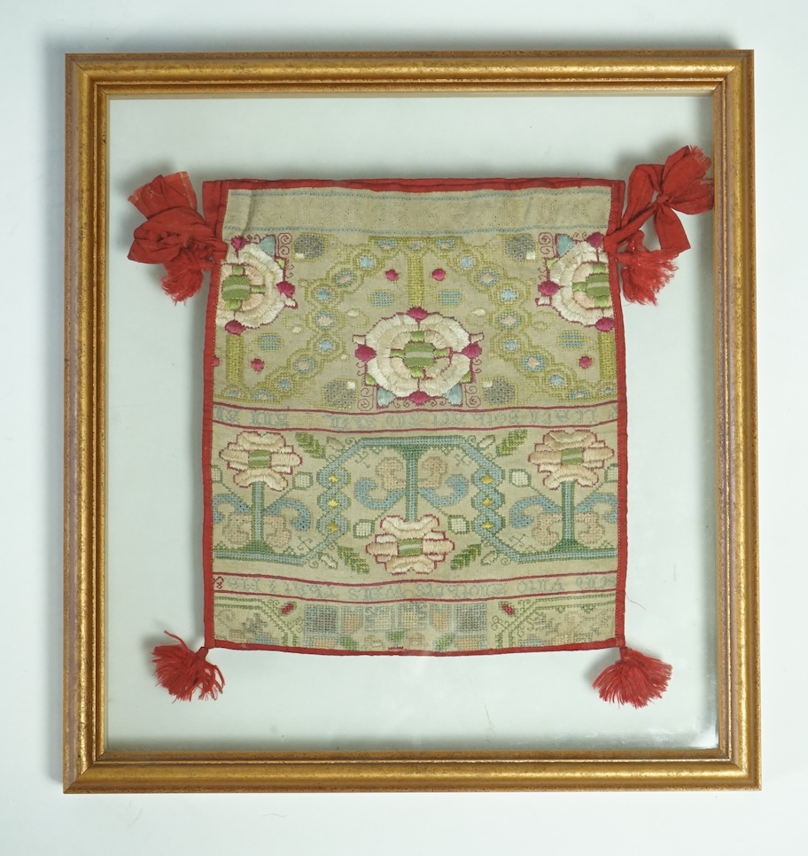 A 18th century long cross stitch sampler, converted later in the early 19th century into a bible bag and then later framed. The sampler worked in rows of alternate religious verse and floral embroidery. The sampler then